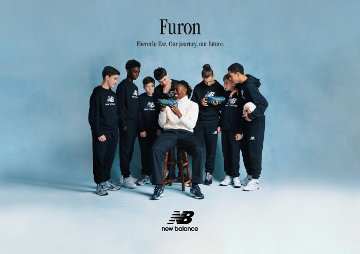 Eberechi Eze shows his soccer boot to fans.